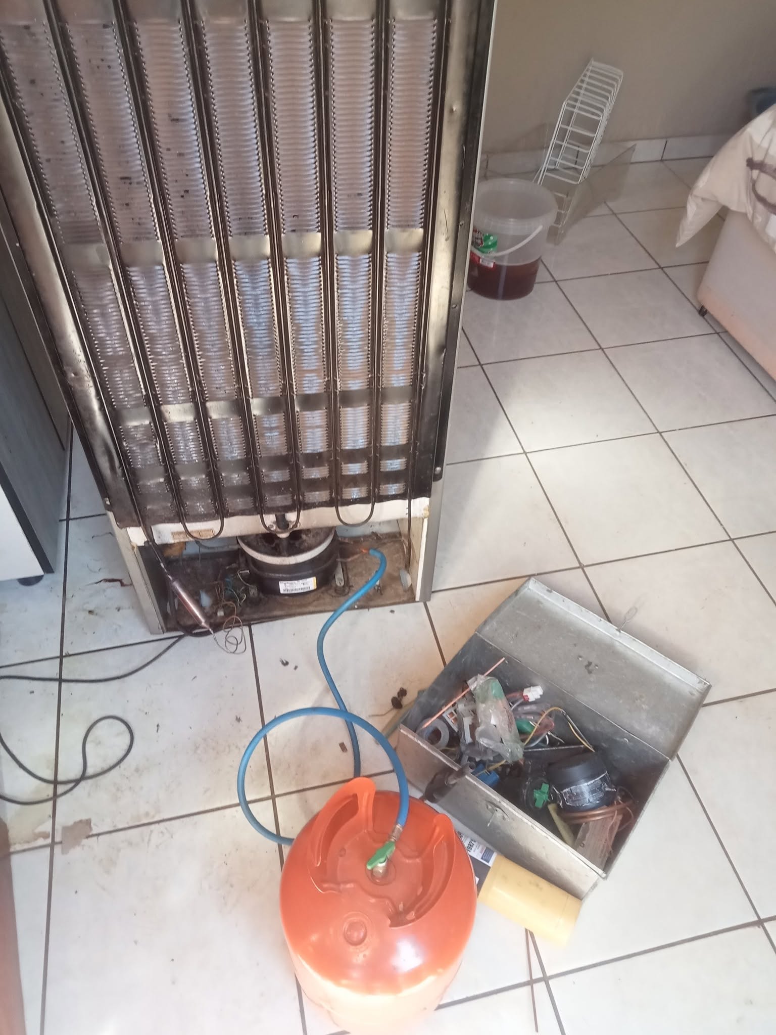 Fridge being serviced on site with a gas cylinder