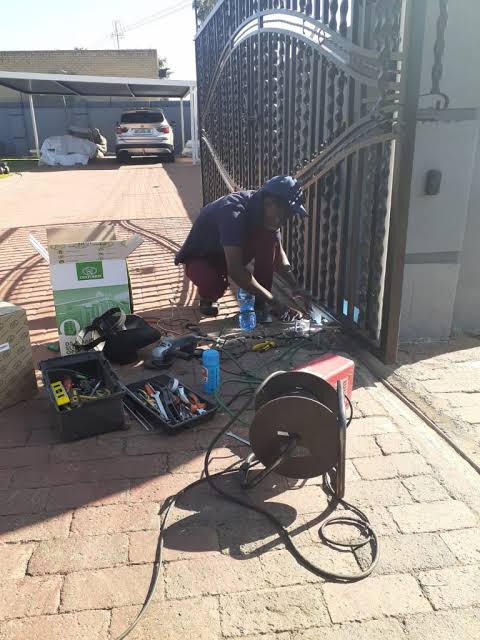 Ornate driveway gate being welded